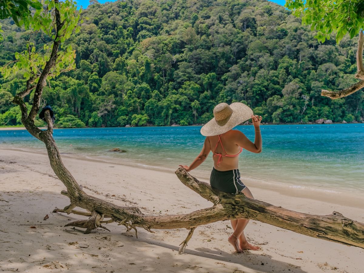 Traveller enjoying a quiet white-sand beach in the Surin Islands