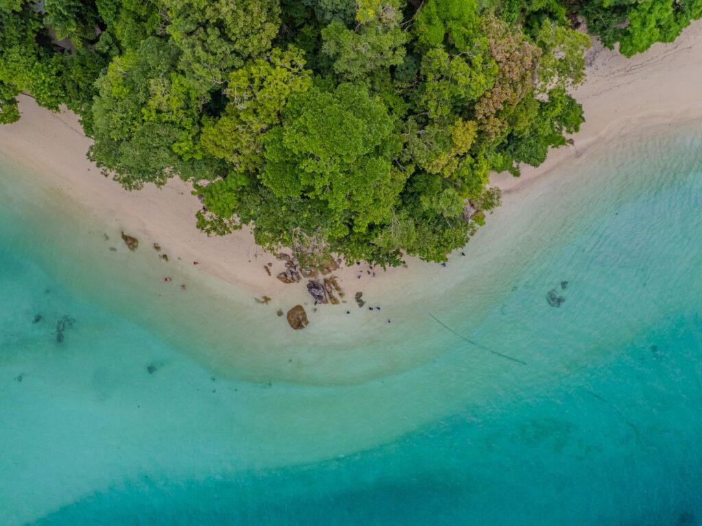 Aerial view of turquoise water and a tropical beach in the Surin Islands