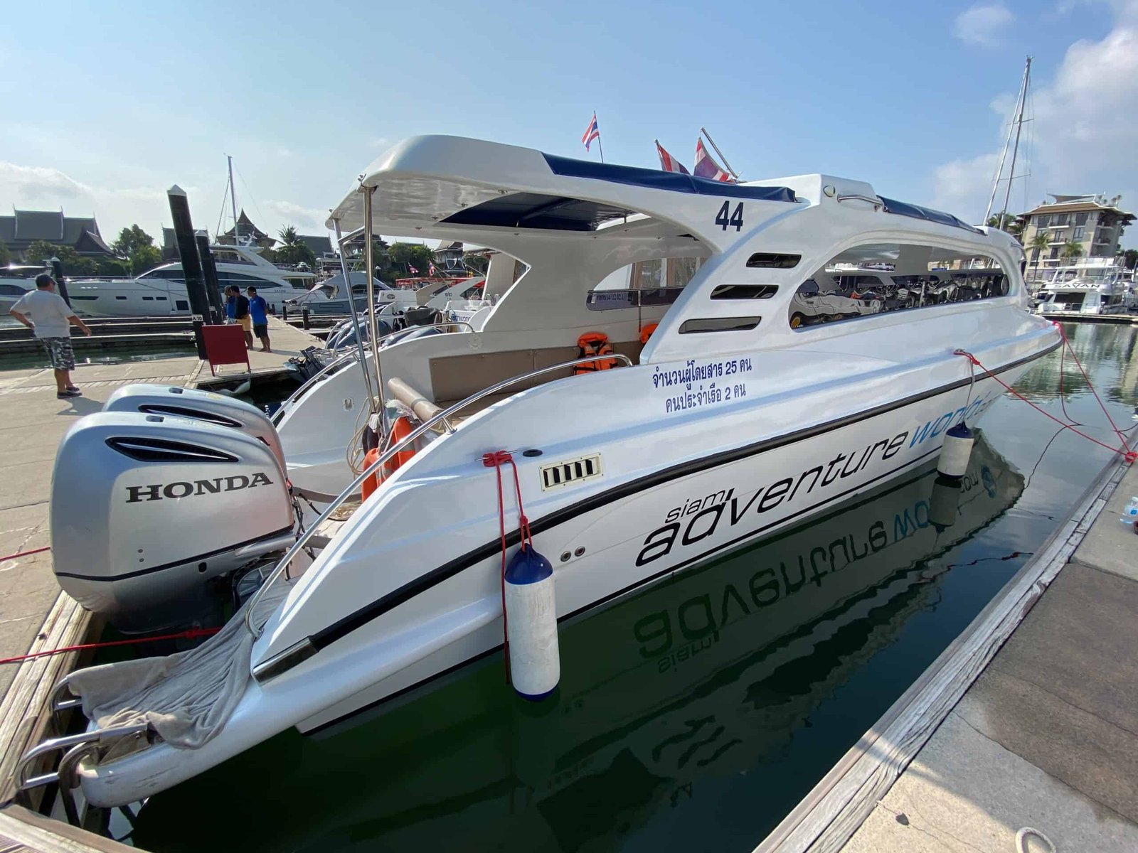 Two-engine Early Bird speedboat with covered seating and two outboard motors