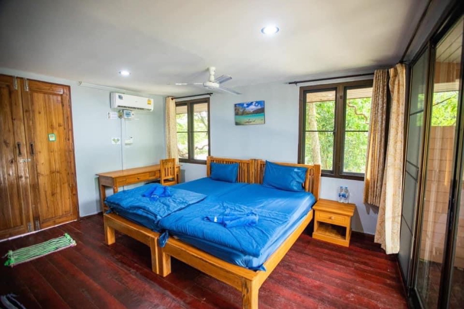 Simple air-conditioned bungalow bedroom inside Mu Ko Surin National Park