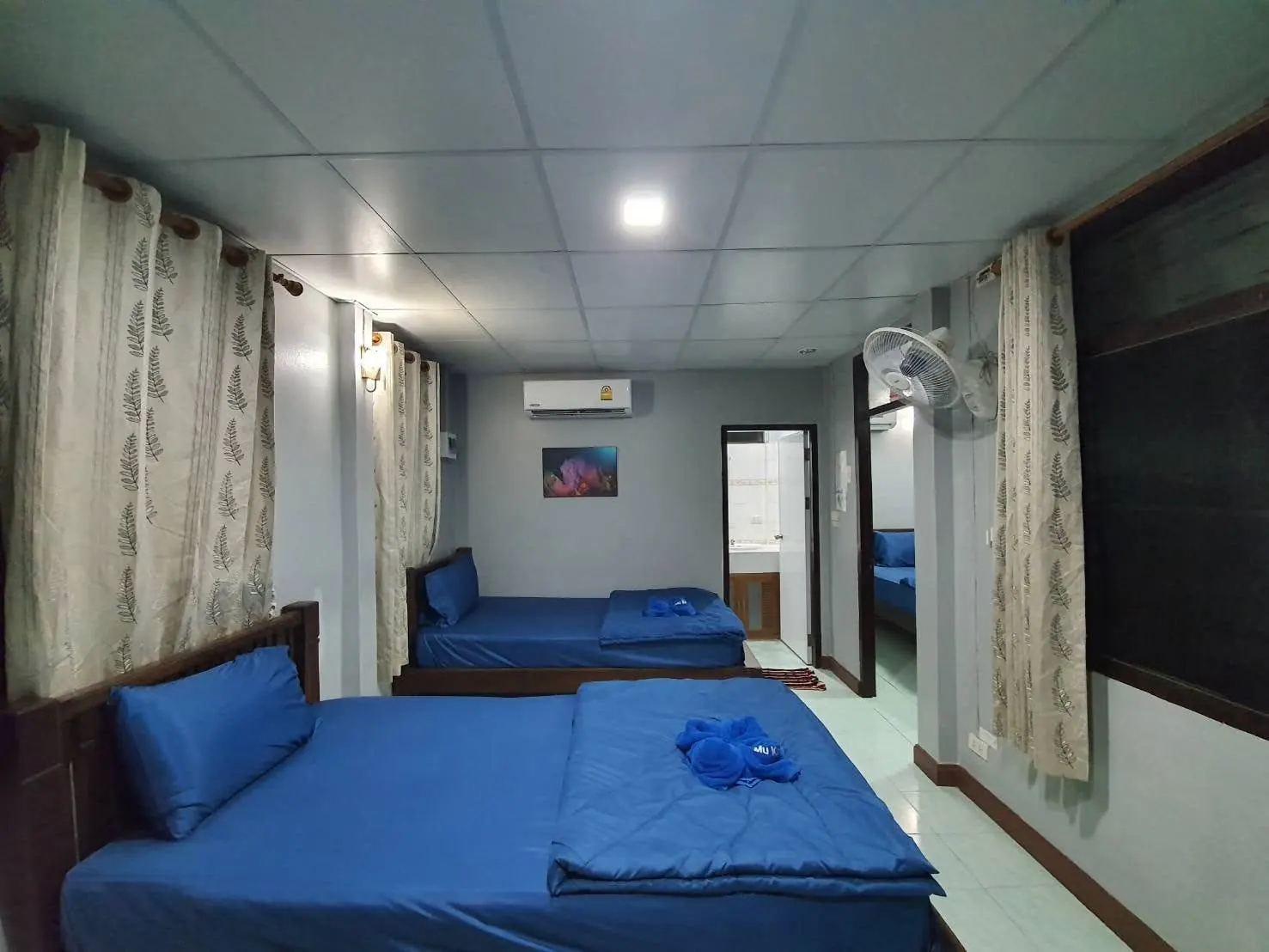 Family bungalow bedroom with the second bedroom visible through the doorway