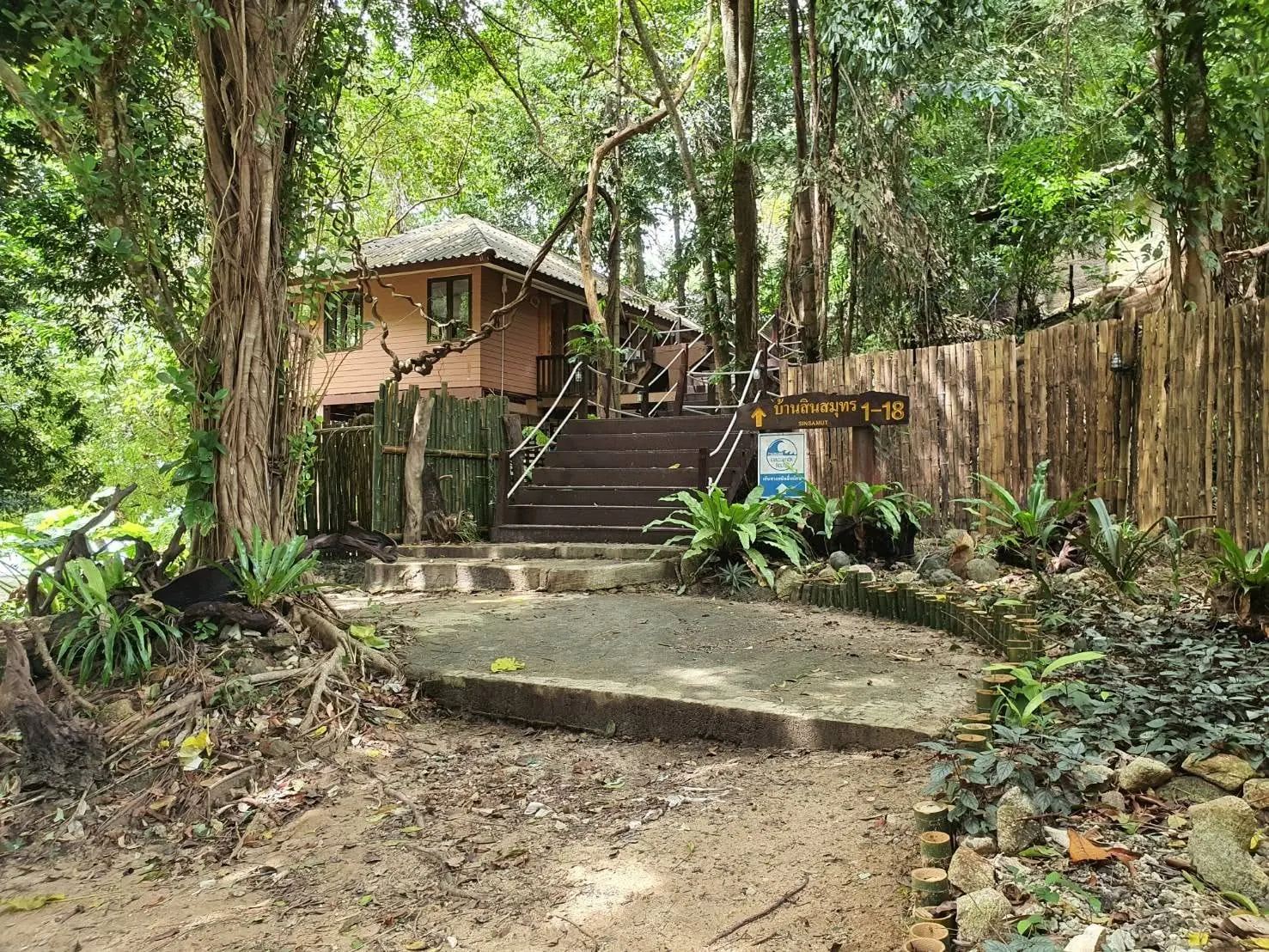 Exterior entrance and steps leading to the two-person bungalows among tropical trees